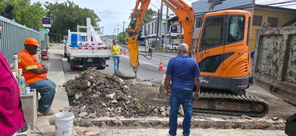 Excavator and work crew carrying out roadworks along O'Meara corridor