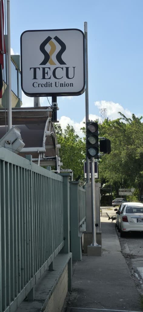 TECU Credit Union sign with signal equipment on the sidewalk