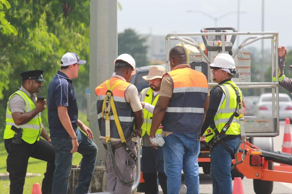 TERI LTD field crew collaborating at a roadside work zone with aerial equipment